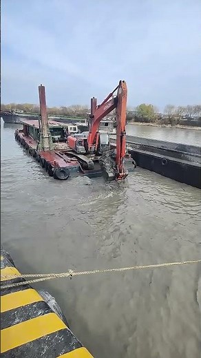 Excavator on Barge Dredging the River