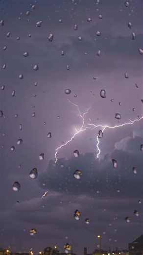 lightning storm through a rainy window
