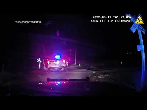 Officer who put woman in a police car hit by a train didn't know it was on the tracks, defense says