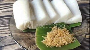 Jadah, a traditional Javanese cake, is made by steaming until cooked. Its soft and fluffy texture pairs perfectly with coconut srundeng made from grated coconut sauteed with spices. A savory and sweet
