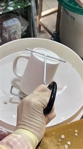 Base color added to the new clay cup, forming a smooth start before further painting begins now here