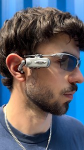2005 Oakley X Motorola Mercury/ Gray’ RAZRWire Bluetooth Sunglasses Oakley sunglasses with a built in MP3 audio player. The headphones are integrated directly into the stems and can be flipped up when not in use. This model comes in 2 parts. The Bluetooth headset clamps onto the side of the sunglasses metal frame, and can be paired to your phone. A true innovation as expected from Oakley. #gorpcore #techwearfashion | Second Wave Vintage