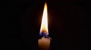 Download Soft Candle Flame Flickering in a Dark Room for free