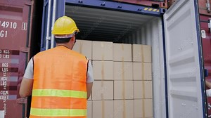 Foreman and a worker help opening containers together and lifting the box while female assistant check stock by computer at the transport warehouse. Cargo container and Transport Logistic concept