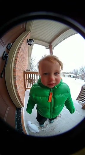 Doorbell Cam: Toddler in Snow Gets Hat Blown Off (Then Kisses the Camera!)
