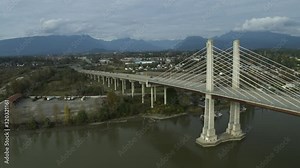 4K Aerial footage of the Golden Ears Bridge in Maple ridge connecting Langley over the Fraser River. Moving away from bridge looking at Maple Ridge.