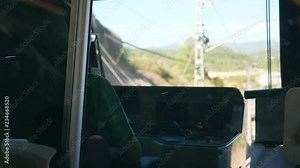 Unrecognizable train driver drives electrical train among mountain road. Point of view from driver cabin to railway tracks. Rear back view POV Slow motion Close up