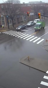 Traffic Camera Captures Violent Intersection Crash as Car Runs Red Light and Slams Into Delivery Truck Pittsburgh, Pennsylvania – November 23, 2025 A rainy morning turned dangerous in an instant when a traffic camera overlooking a busy downtown intersection recorded a high-speed collision between a silver SUV and a green delivery truck. The roads glistened with fresh rainfall, making the pavement slick and visibility poor — conditions that played a major role in what unfolded. The footage shows 