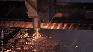 Slow motion: automatic cnc laser cutting machine working with sheet metal with sparks at factory, plant. Metalworking, machining, industrial, equipment, technology, manufacturing concept