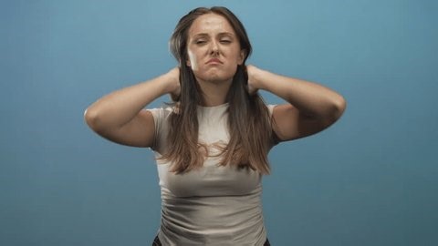 clip-3996128553-woman-young-brunette-bare-arms-tilting-head