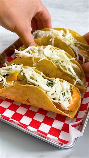 We took a fast food icon and gave it the Twisted treatment. Crispy fish, tangy sauce, soft taco shell. The Filet-O-Fish has never looked (or tasted) so good 😉 Ingredients 2 breaded white fish fillets 4 small flour tortillas (6-inch size) 4 cheese singles 2 tbsp neutral oil (vegetable or sunflower) 4 heaped tbsp tartare sauce 100g shredded iceberg lettuce (about 25g per taco) 3–4 pickles or gherkins, sliced or chopped ½ lemon, cut into wedges for serving Optional: small handful fresh dill or par