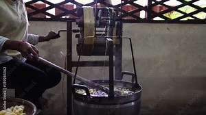 Reeling the silk, separating silk thread from silk cocoon. raw silk handmade production in village factory. before silk is woven into textiles.