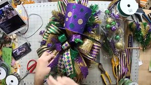 2.4K views · 81 reactions | Today on the blog, we are showing y'all how to make a gorgeous Mardi Gras swag! This one is glitzy and glamorous and we love it! See the written instructions and supply list here: https://howtomakewreaths.com/mardi-gras-swag/ | DecoExchange | Facebook