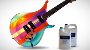 A Beautiful Translucent Electric Guitar Made Out of Multi-Colored Epoxy Resin With a Purple Wooden Neck