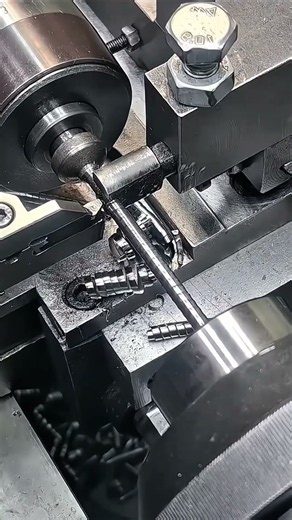 A Metal Lathe Cuts Precision Threads on a Steel Rod