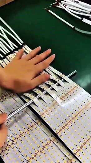 Handling multiple LED light strips during assembly process