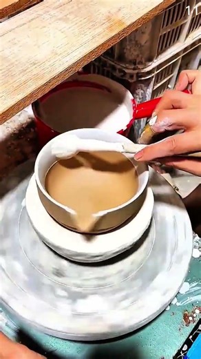 Centering clay bowl using potter’s wheel and hands