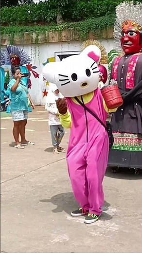 Hello Kitty clown dancing with ondel-ondel