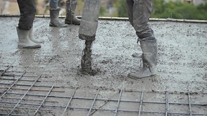 Workers pouring concrete at a construction site