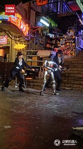 9K views · 143 reactions | Chinese start-up EngineAI released a demo video in which a humanoid robot developed by the company wields two axes and shows off dance moves from the 2004 film Kung Fu Hustle alongside two professional dancers. | China Focus | Facebook