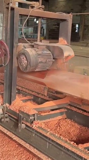 cutting large wooden logs into square beams using an industrial saw machine with precision
