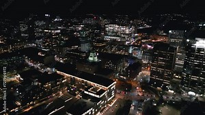 Cinematic drone shot of the Halifax cityscape at night. Aerial view of Halifax entertainment and business districts, city skyline with skyscrapers at night