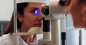 Eye, test and woman at machine with light for medical assessment, evaluation or retina check. Glaucoma, led glow and girl in exam for vision, focus or eyesight scan with health consultant at clinic