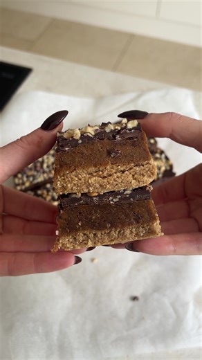 these taste like a kinder bueno on crack gooey, nutty, sweet, salty. pure dessert perfection. good luck making a batch last longer than 24 hours for the base: 1 1/2 cups roasted hazelnuts blended into flour 1/2 cup oat flour 1/4 cup agave/maple syrup 4 tbsp coconut oil 1 tsp vanilla extract pinch sea salt mix everything together in a bowl until you have a moist but slightly crumbly texture. if it seems too dry, add a splash more liquid. press into a lined tray and set aside for the caramel: 1 1/