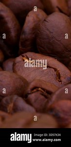 Discover the rich transformation of raw coffee beans as they roast in a local cafe during the early morning hours, filling the air with rich aromas.