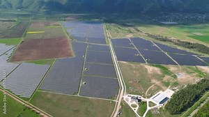 Solar power plant seen from above. solar park generating electricity on a sunny day. Ecological green renewable sustainable energy.