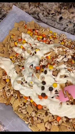 Happy Halloween! Ingredients 1 cup Pretzels 2 cup Honey Nut Cheerios 2 cup Corn Chex 2 cup Candy Corn 1 1/2 cup Reeses Pieces 12 oz White Chocolate Chips 1 tbsp Coconut Oil Top with Halloween Sprinkles Instructions 1 In a large mixing bowl, mix together your dry ingredients. 2 In a smaller bowl, add your white chocolate chips and coconut oil and warm in the microwave in 15 to 20 second increments. Stir in between until you reach a smooth consistency. 3 Add your chocolate mixture over your monste