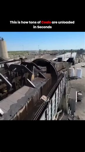 Poweredresearch on Instagram: "This video showcases an impressive feat of industrial engineering: a rotary railcar dumper in action. The footage captures a massive mechanical cradle gripping an entire train car filled with coal and rotating it nearly 180 degrees. ​As the car tips, tons of coal cascade into a subterranean hopper in just seconds. This process is remarkably efficient because it uses specialized rotary couplers, allowing individual cars to be inverted without uncoupling them from th
