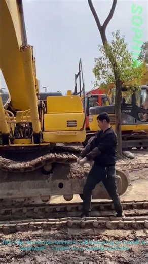 Workers Installing Excavator Track – Muddy Site Heavy Equipment Task