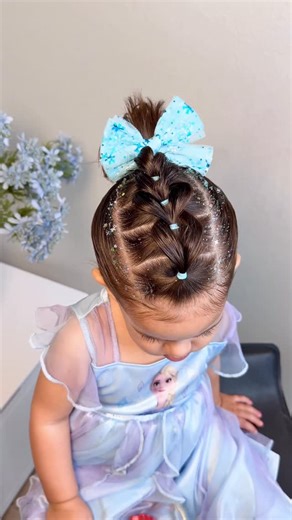 @hairbyadelia on Instagram: "Nothing is cuter than this easy Elsa-inspired hairstyle ❄️✨ It came out SO cute… I’m obsessed!!! Elsa bow & glitter: @dittobug_hair Use code ADELIA10 to save 🫶🏻"