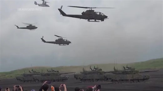 Japan's cabinet approves record defense budget that aims to deter China; AP explains