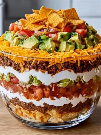 143K views · 1.6K reactions | Towering Seven-Layer Taco Salad A colorful fiesta in a bowl with layers of beef, cheese, veggies, and creamy goodness. Yield: 10 servings Temp: No-bake (chill optional) Time: 25 min Key Ingredients First: Ground beef Shredded cheddar cheese ....................... FULLL Recipe in First Cօʍʍеոτ  | Cake Shake | Facebook