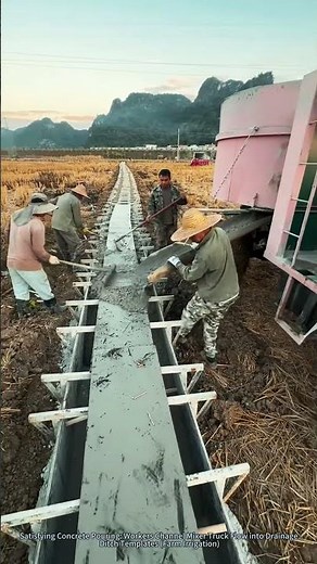 Satisfying Concrete Pouring: Workers Channel Mixer Truck Flow into Drainage Ditch Templates
