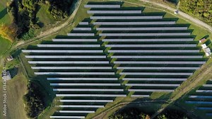 Slow aerial descent reveals a vast array of solar panels at a Greek solar farm, highlighting robust renewable energy infrastructure and modern sustainability.