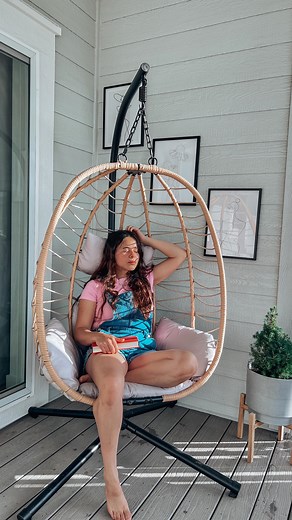 Sabrina Tewksbury - Home Decor - DIY on Instagram: "This amazing Hanging Egg Chair is all I needed for hours or relaxation. It’s beautiful, comfortable, cute and safe. It has a 350lbs capacity plus double chains for safety. It was totally worth the money! Link in bio to snag this beauty before it sells out. Available in 4 different colors. Download the @temu app to shop! #shoptemu #temu #temufinds #temumusthaves #temuporch #eggchair #backporchchillin #backporchsitting #backporch @shoptemu"