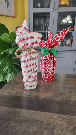 Ikea dish towels as wrapping paper. 🎁 Save the bag, and the paper, and use a towel inatead. These dish towels are nice and big and come in all kinds of seasonal patterns. Wrap up a bottle of wine and tie it off with a coordinating ribbon. Gift the bottle and the towel to a lucky friend. #giftwrapping #crafty #crafter #winelovers #giftideas #diygifts #sustainableliving #hostessgift | Creative Ramblings