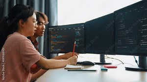 Back end software developer engineer for computer programming working together on debugging writing computing code, solving complex algorithms display on monitor in office. Burgeoning Stock Video