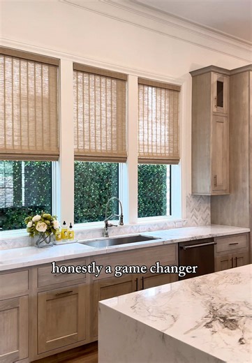 This kitchen got a major upgrade with woven motorized shades! Great light, built-in privacy, and effortless control. ✨⁠ ⁠ ⁠ ⁠ #CreativeBlinds #WovenShades #MotorizedShades #KitchenDesign #HoustonHomes⁠