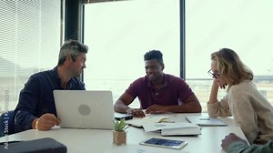 Mixed race group of business workers working together on collaboration project