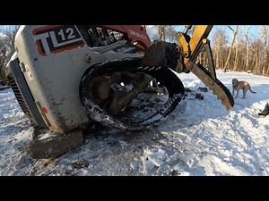 Installing new tracks on a track loader