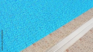 Beautiful blue turquoise water in the pool, water waves. Summer holidays spa and pool. Copy space for your text. Blue, turquoise, azure background. Sunny bunny and sun flare.