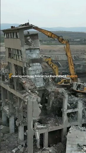 Long Reach Excavator Demolishing Tall Building