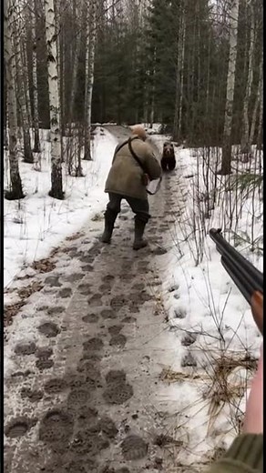 Hunter Backs Away From Angry Bear in Russian Far East Forest
