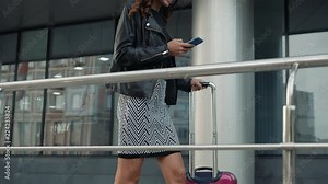 Portrait of a girl using the voice recognition of the phone and looking at cell phone near airport terminal in hotel on vacation tourist speech personal assistant natural language user interface audio Stock Video