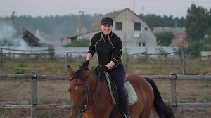 Woman riding horse by gallop