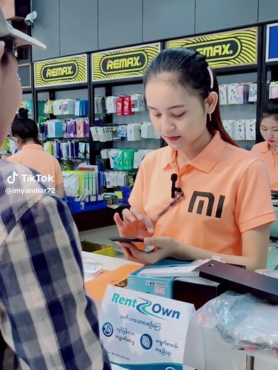 Electronics Store Employee Assists Customer with Products
